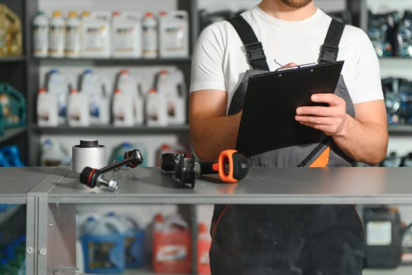 Auto parts store. The seller receives the product and evaluates the quality.